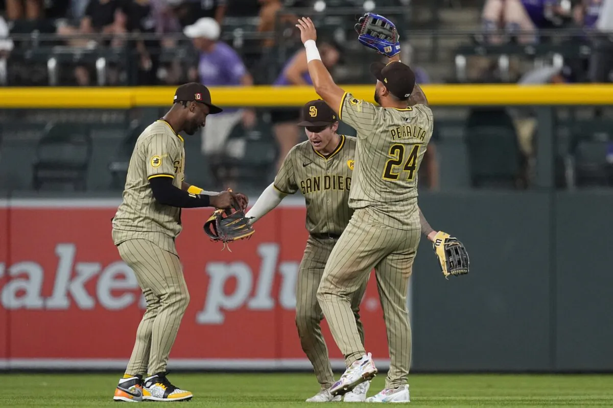 From (L) San Diego Padres left fielder Jurickson Profa (C) fielder Bryce Johnson and right fielder David Peralta celebrate after a victory over the Colorado Rockies in a baseball game in Denver on Aug. 17, 2024. (David Zalubowski/AP Photo)