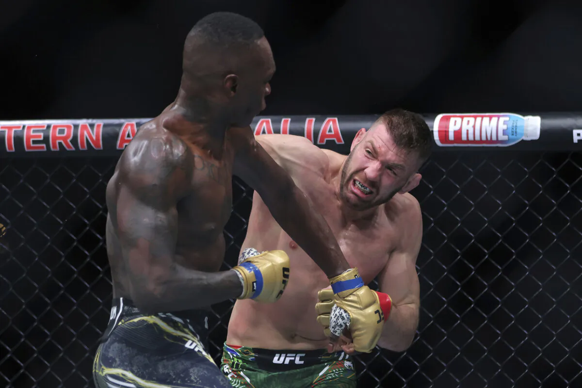 Dricus du Plessis (R) of South Africa and Israel Adesanya of Nigeria fight during their Middleweight title bout at UFC 305 at RAC Arena in Perth, Australia, on Aug. 18, 2024. (Richard Wainwright/AAP Image via AP)
