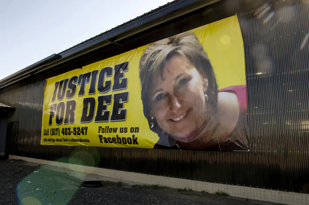 A banner shows a photo of missing woman Dee Warner in Tipton, Mich., on May 9 2022. (Jacob Hamilton/Jackson Citizen Patriot via AP)