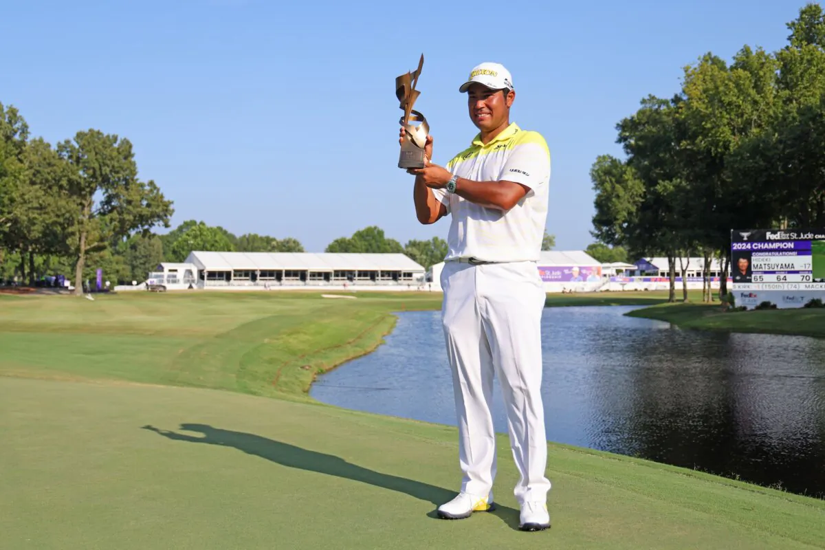 Hideki Matsuyama of Japan poses with the trophy after winning the FedEx St. Jude Championship in Memphis, Tenn., on Aug. 18, 2024. (Mike Mulholland/Getty Images)