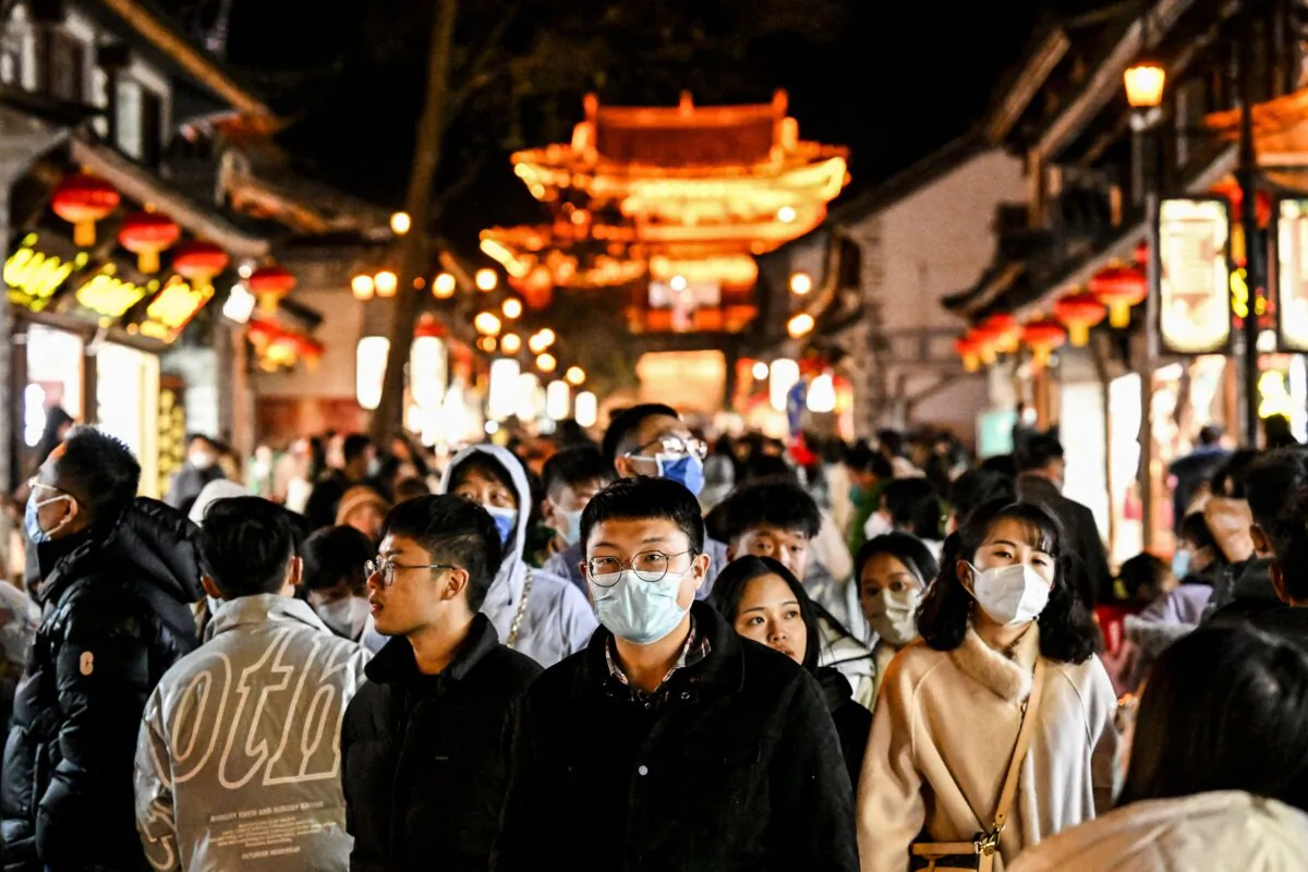 People walk down the street in Dali town, a township-level division in Dali City, in China's northwest of Yunnan province on Jan. 14, 2023. (Noel Celis/AFP via Getty Images)