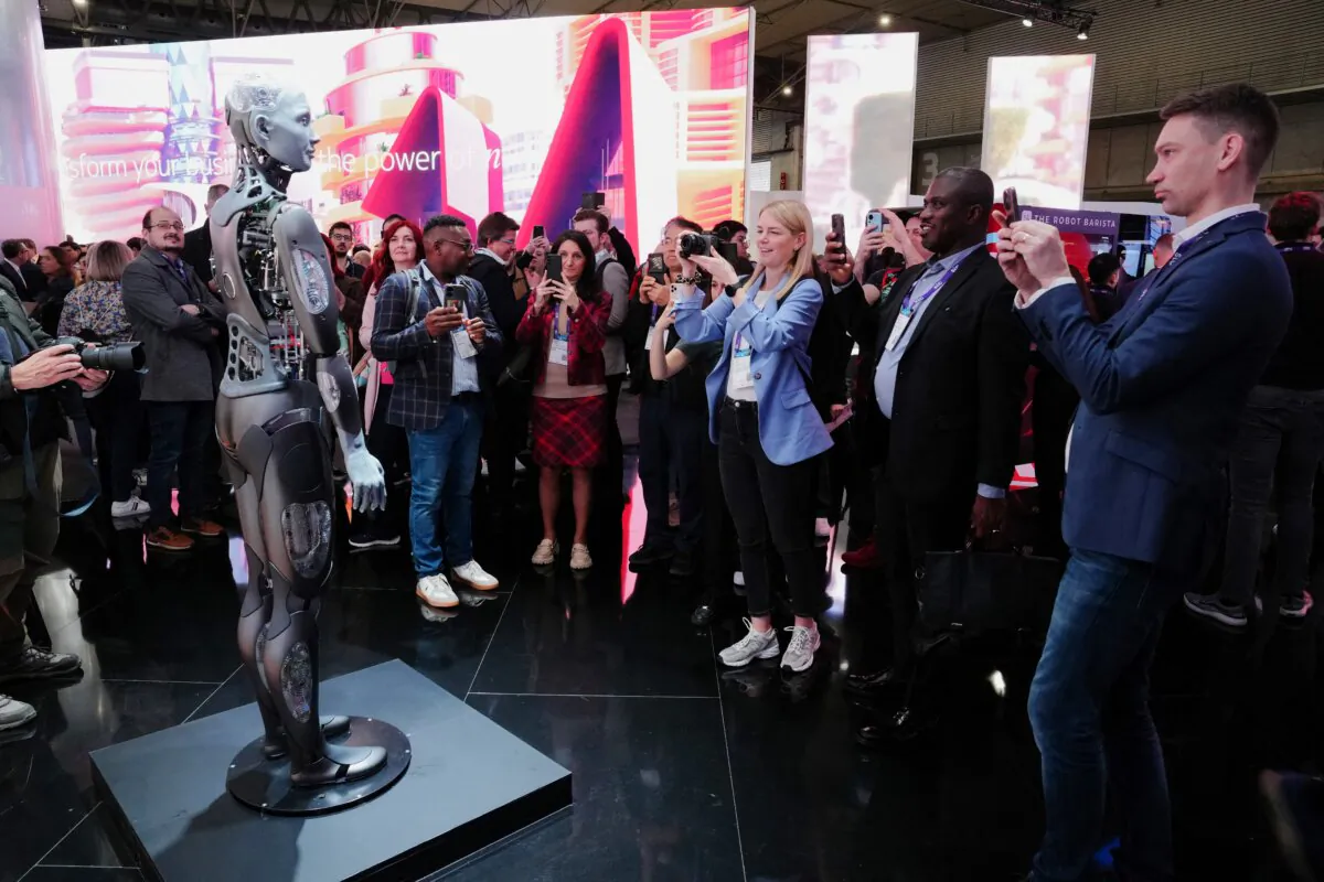 Visitors take pictures of a robot during the Mobile World Congress in Barcelona, Spain, on Feb. 26, 2024. (Pau Barrena/AFP via Getty Images)