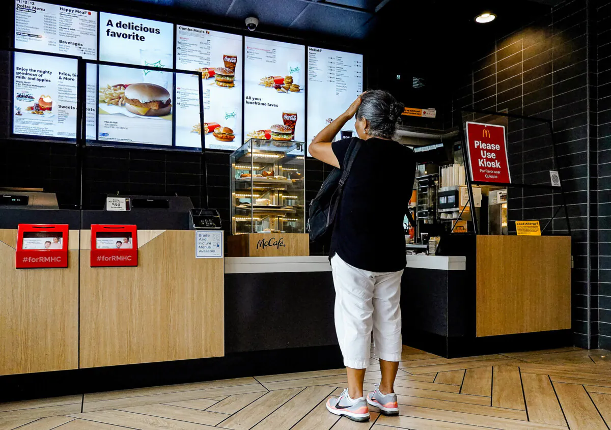 A customer waits to order food at a McDonald's fast-food restaurant in Miami on July 26, 2022. (Photo by Joe Raedle/Getty Images)
