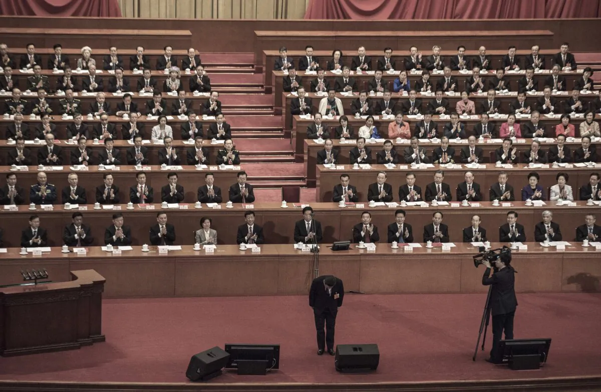 China's President Xi Jinping, bottom, bows before his speech during the closing session of the National People's Congress at The Great Hall Of The People on March 20, 2018 in Beijing, China. (Kevin Frayer/Getty Images)