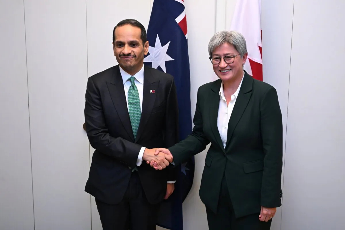 Prime Minister of Qatar Mohammed bin Abdulrahman bin Jassim Al Thani shakes hands with Australian Foreign Minister Penny Wong during a meeting at Parliament House in Canberra, Australia, on Aug. 20, 2024. (AAP Image/Lukas Coch)