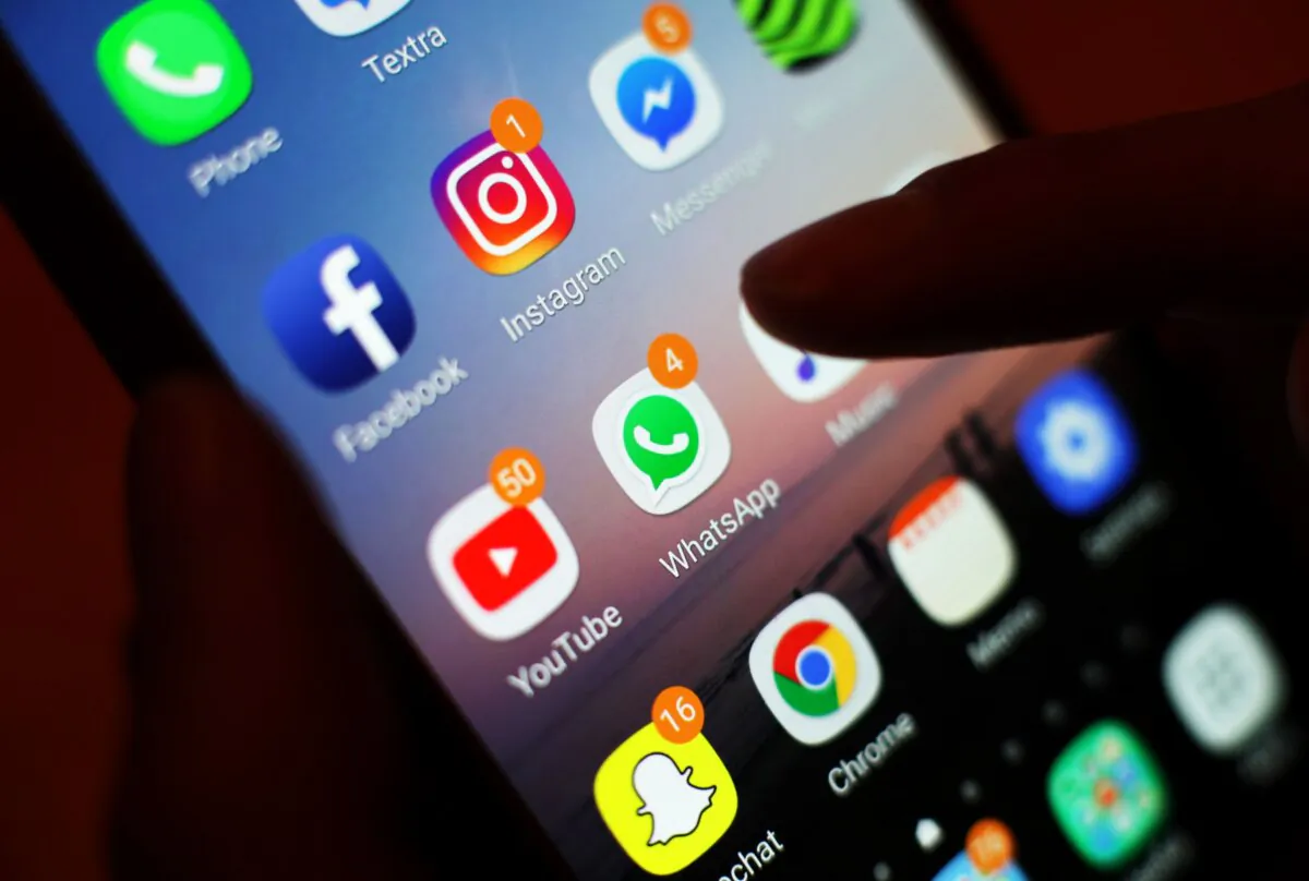 Icons of social media apps, including Facebook, Instagram, YouTube, and WhatsApp, are displayed on a phone screen on Jan. 3, 2018. (Yui Mok/PA) 