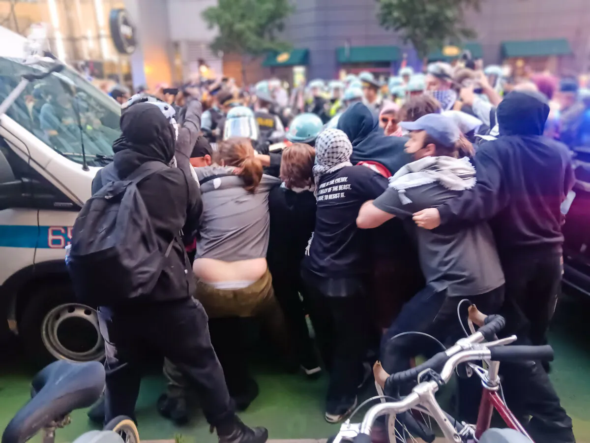 Chicago police and pro-Palestinian protesters clash outside the Israeli consulate in Chicago, on Aug. 20, 2024. (Nathan Worcester/The Epoch Times)
Nathan Worcester
Joseph Lord