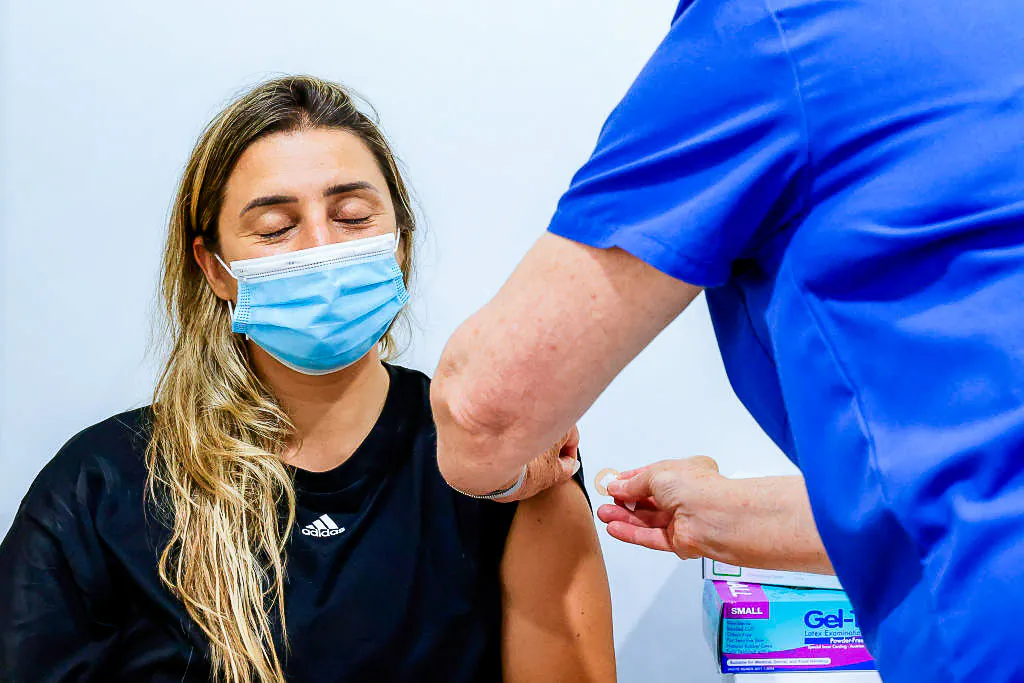 A woman closes her eyes while receiving a COVID-19 vaccine at Sydney Road Family Medical Practice in Balgowlah, in Sydney on Jan. 10, 2022. (Jenny Evans/Getty Images)