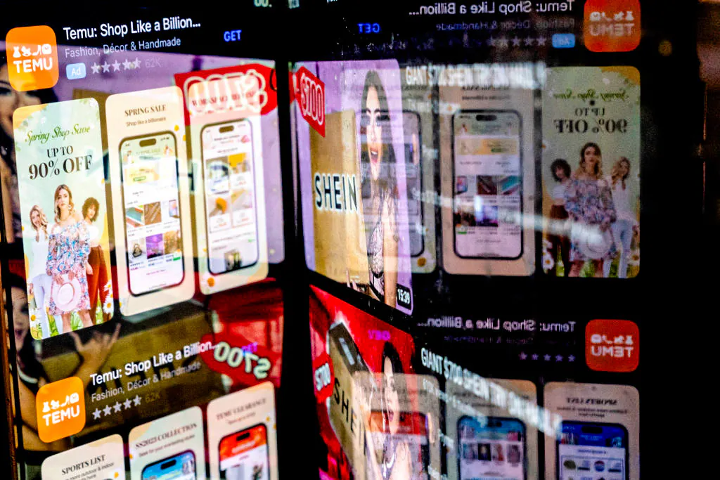 This photo illustration shows the Temu app in the App Store reflected in videos of Shein consumers in Washington on Feb. 23, 2023. (Stefani Reynolds/AFP via Getty Images)
