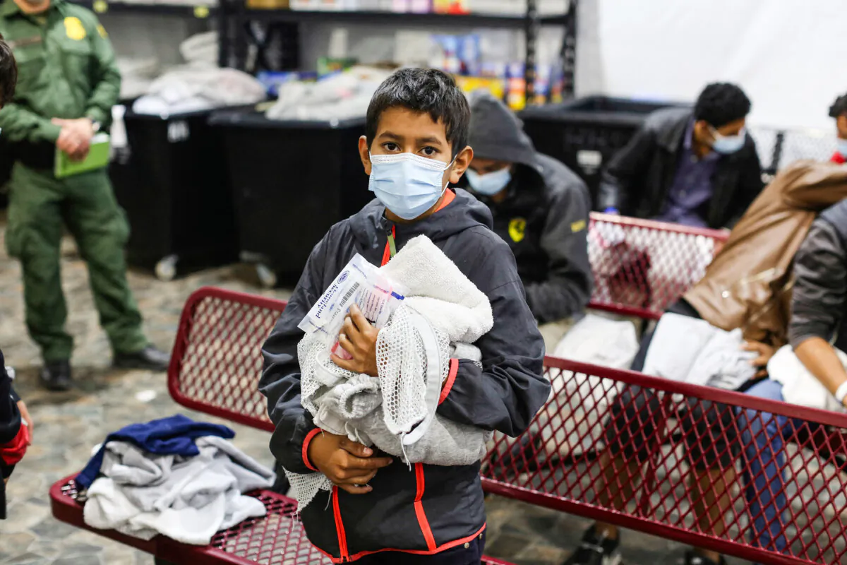 An unaccompanied child waits to take a shower at the Department of Homeland Security's main detention center for unaccompanied illegal immigrant children in Donna, Texas, on March 30, 2021. (Dario Lopez-Mills/AFP via Getty Images)