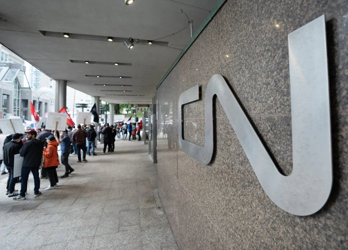 Rail workers picket in front of CN headquarters in Montreal on Aug. 22, 2024, the first day of a nationwide rail shutdown, after workers were locked out by CN and CPKC when new contract agreements weren't reached by the midnight deadline. (The Canadian Press/Ryan Remiorz)