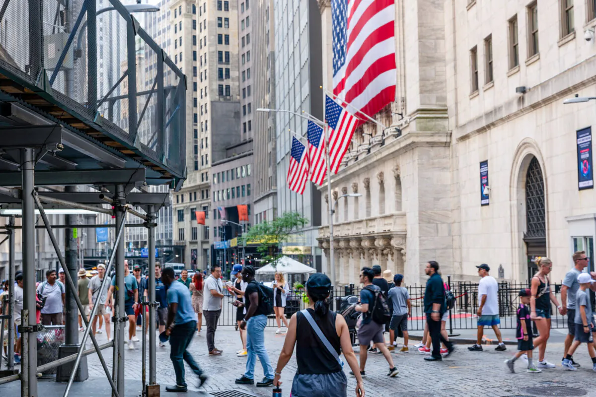 People pass the New York Stock Exchange in New York on July 5. (Spencer Platt/Getty Images)