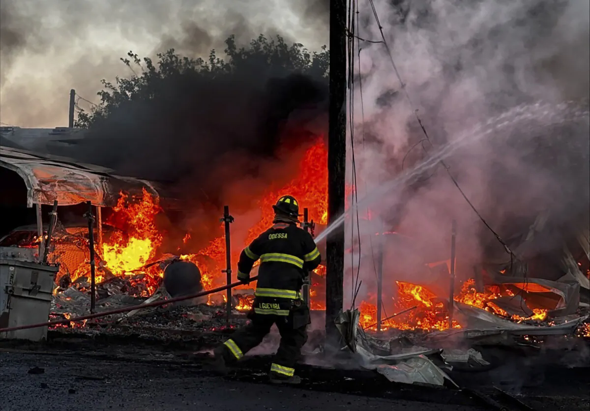 A firefighter works on the scene of a plane crash in Odessa, Texas, on Aug. 20, 2024. (Mark Matta via AP)