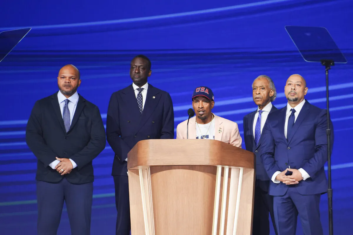 Korey Wise (C) speaks on stage as Kevin Richardson (L), New York City council member Dr. Yusef Salaam (2nd L), Rev. Al Sharpton (2nd-R), and Raymond Santana (R) look on during the last day of the Democratic National Convention in Chicago on Aug. 22, 2024. (Madalina Vasiliu/The Epoch Times)