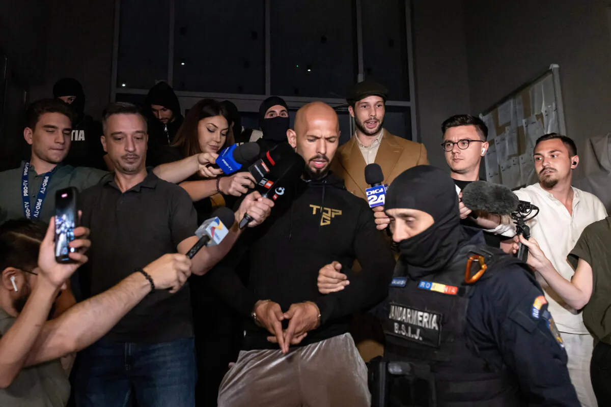 Andrew Tate and his brother Tristan are escorted outside the Directorate for Investigating Organized Crime and Terrorism (DIICOT), in Bucharest, Romania, on Aug. 21, 2024. (Inquam Photos/Sabin Cirstoveanu via Reuters)
