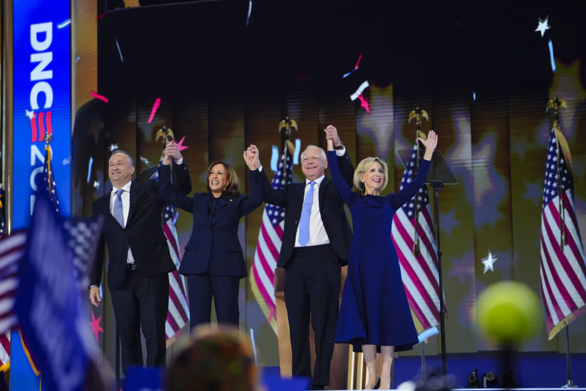 (L-R) Second Gentleman Douglas Emhoff, Vice President and Democratic presidential candidate Kamala Harris, Minnesota Governor and Democratic vice presidential candidate Tim Walz and Gwen Walz on the last day of the Democratic National Convention, in Chicago on Aug. 22, 2024. (Madalina Vasiliu/The Epoch Times)