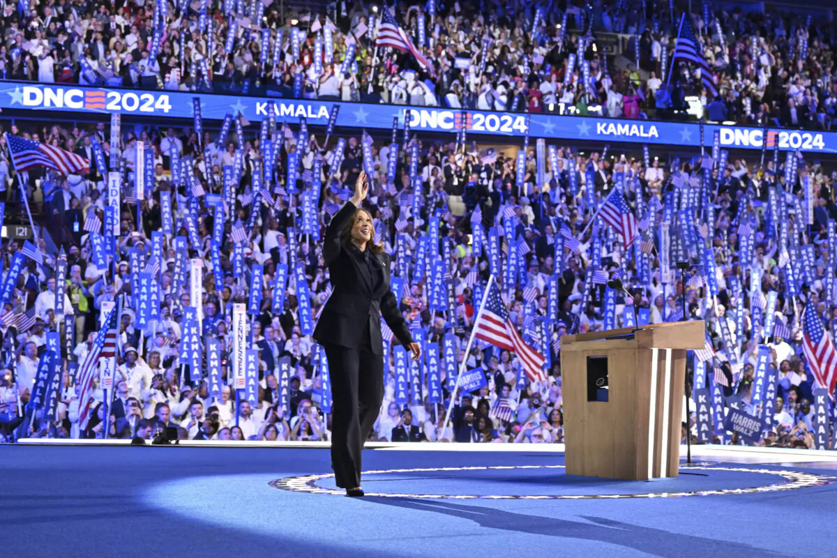 TOPSHOT - US Vice President and 2024 Democratic presidential candidate Kamala Harris waves as she arrives onstage to speak on the fourth and last day of the Democratic National Convention (DNC) at the United Center in Chicago, Illinois, on August 22, 2024. (Photo by Robyn Beck / AFP) (Photo by ROBYN BECK/AFP via Getty Images)