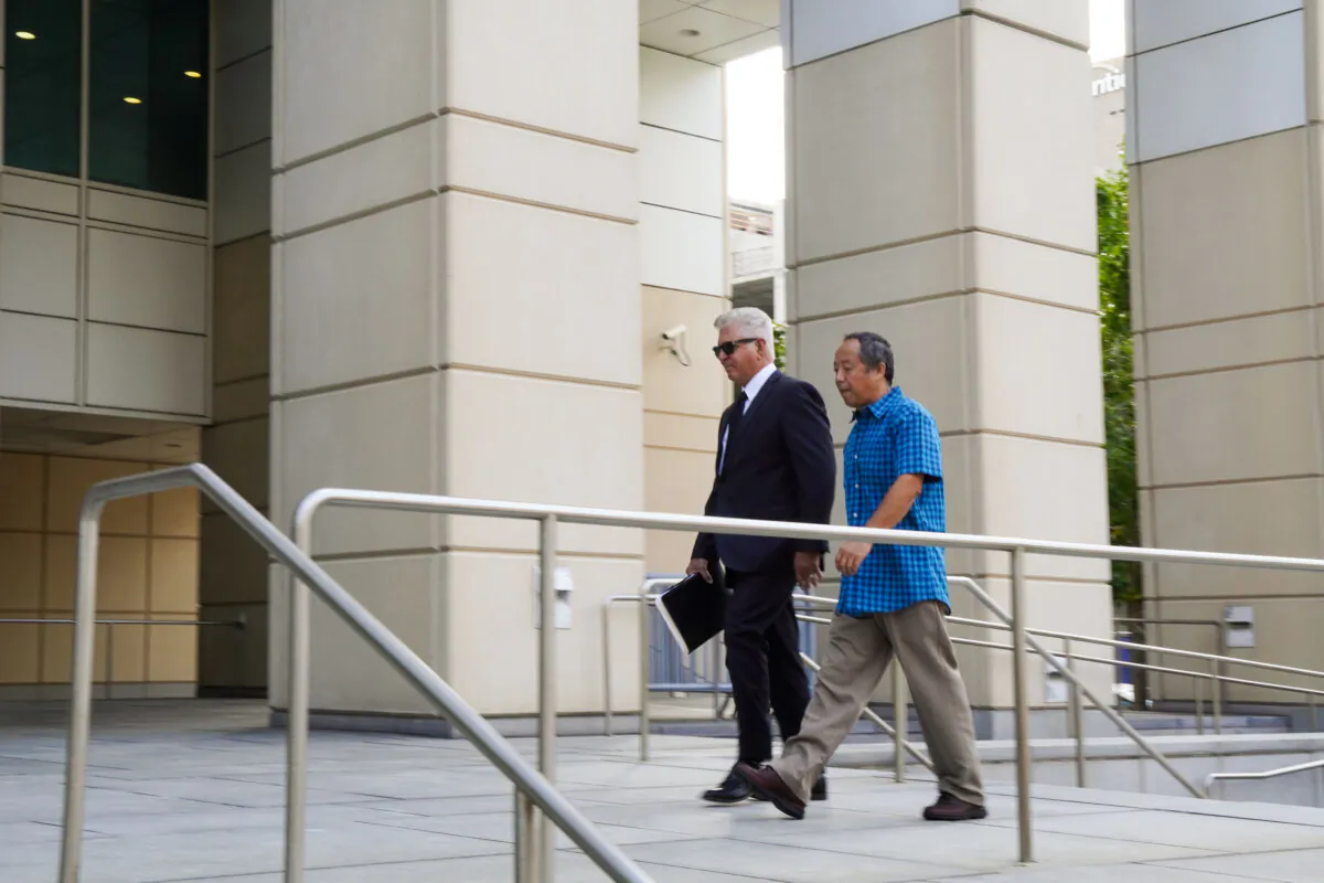 Ping Li and his lawyer Daniel Fernandez arrive at the United States District Court for the Middle District of Florida ahead of a court hearing in Tampa, Fla., on Aug. 23, 2024. (T.J. Muscaro/The Epoch Times)