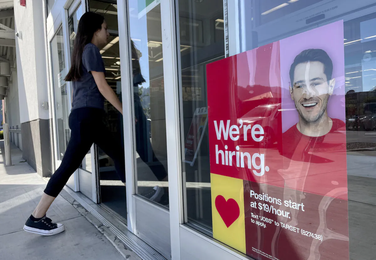 A customer walks by a 'We're Hiring' sign posted in front of a Target store in Sausalito, Calif., on Nov. 3, 2023. (Justin Sullivan/Getty Images)