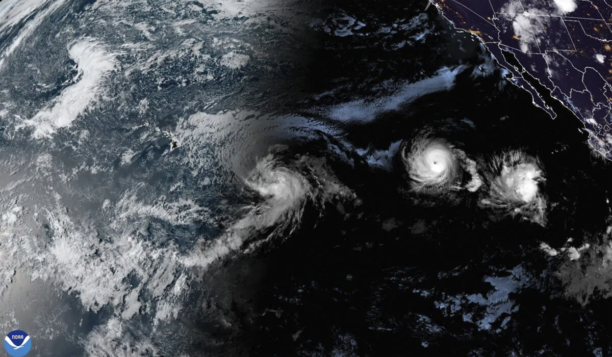A satellite image shows Tropical Storm Hone and Hurricane Gilma located southeast of Hawaii, on Aug. 22, 2024. (NOAA via AP)