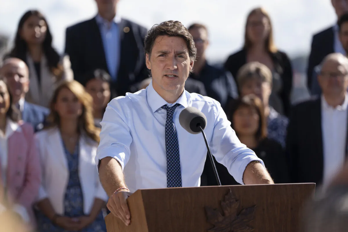 Prime Minister Justin Trudeau speaks to reporters as cabinet members look on during the Liberal cabinet retreat in Charlottetown, P.E.I. on Aug. 23, 2023. (The Canadian Press/Darren Calabrese)