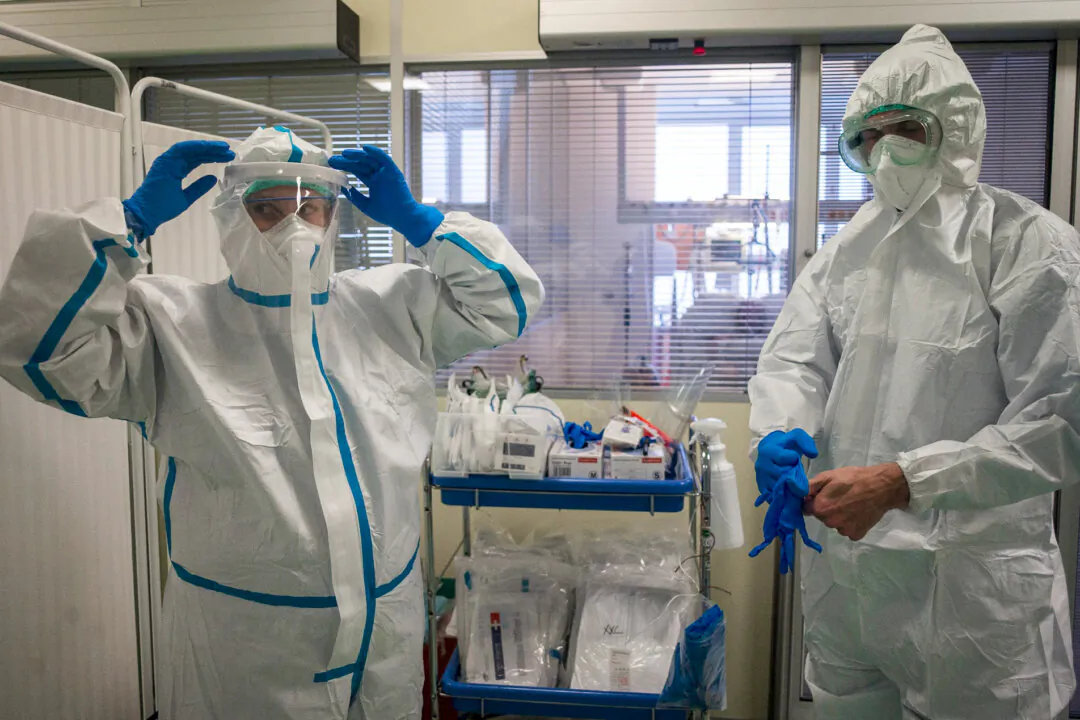 Health care workers put on personal protective equipment (PPE) at an intensive care unit (ICU) at Thomayer hospital, in Prague, Czech Republic, on Oct. 14, 2020. (Michal Cizek/AFP/Getty Images)