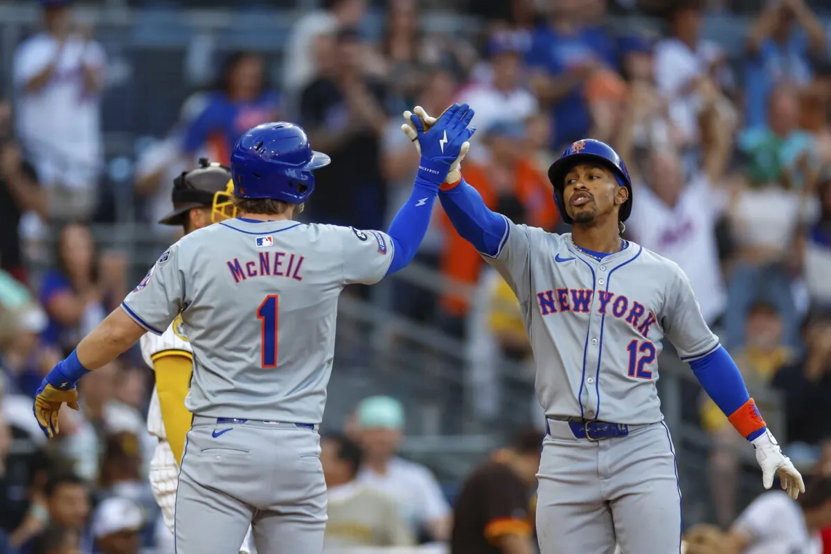 New York Mets' Francisco Lindor (12) celebrates with Jeff McNeil (1) after hitting a grand slam during the fourth inning of a baseball game against the San Diego Padres in San Diego on Aug. 24, 2024. (Brandon Sloter/AP Photo)