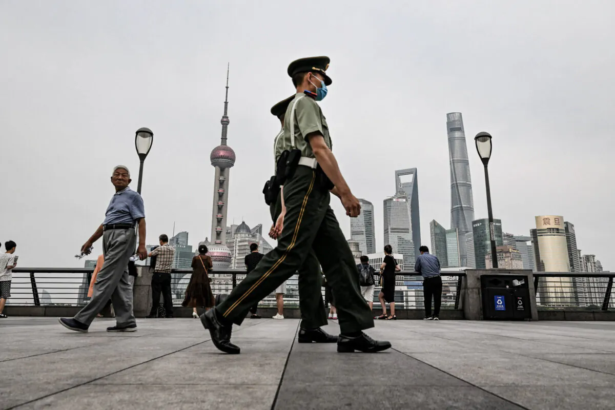 Chinese paramilitary police walk on the Bund promenade along the Huangpu River in the Huangpu District in Shanghai on June 15, 2023. (Hector Retamal/AFP via Getty Images)
