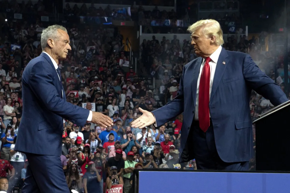 Independent presidential candidate Robert F. Kennedy Jr. and the Republican presidential nominee, former President Donald Trump (R), shake hands during a campaign rally at Desert Diamond Arena in Glendale, Ariz., on Aug. 23, 2024. (Rebecca Noble/Getty Images)