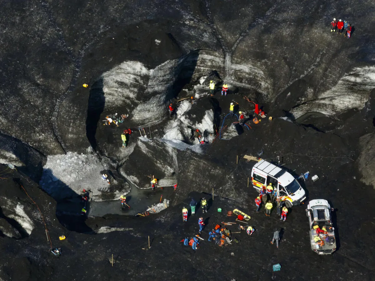 Rescue teams work at the scene after an ice cave partially collapsed, at the Breidamerkurjokull glacier, in southeastern Iceland, on Aug, 26, 2024. (STOD2/Vilhelm Gunnarsson via AP)