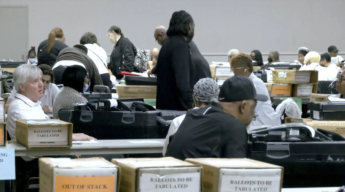 Election authorities begin sorting through and counting ballots at Detroit’s Huntington Place convention center in Detroit, Mich., on Feb. 27, 2024, in a still from video. (Reuters/Screenshot via NTD)