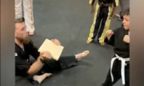 Children in Karate Class Cheer Kid on While Kicking Board