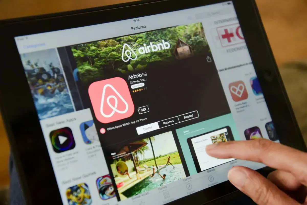 A woman browses the Airbnb website on a tablet in Berlin on April 28, 2016. (John MacDougall/AFP via Getty Images) 