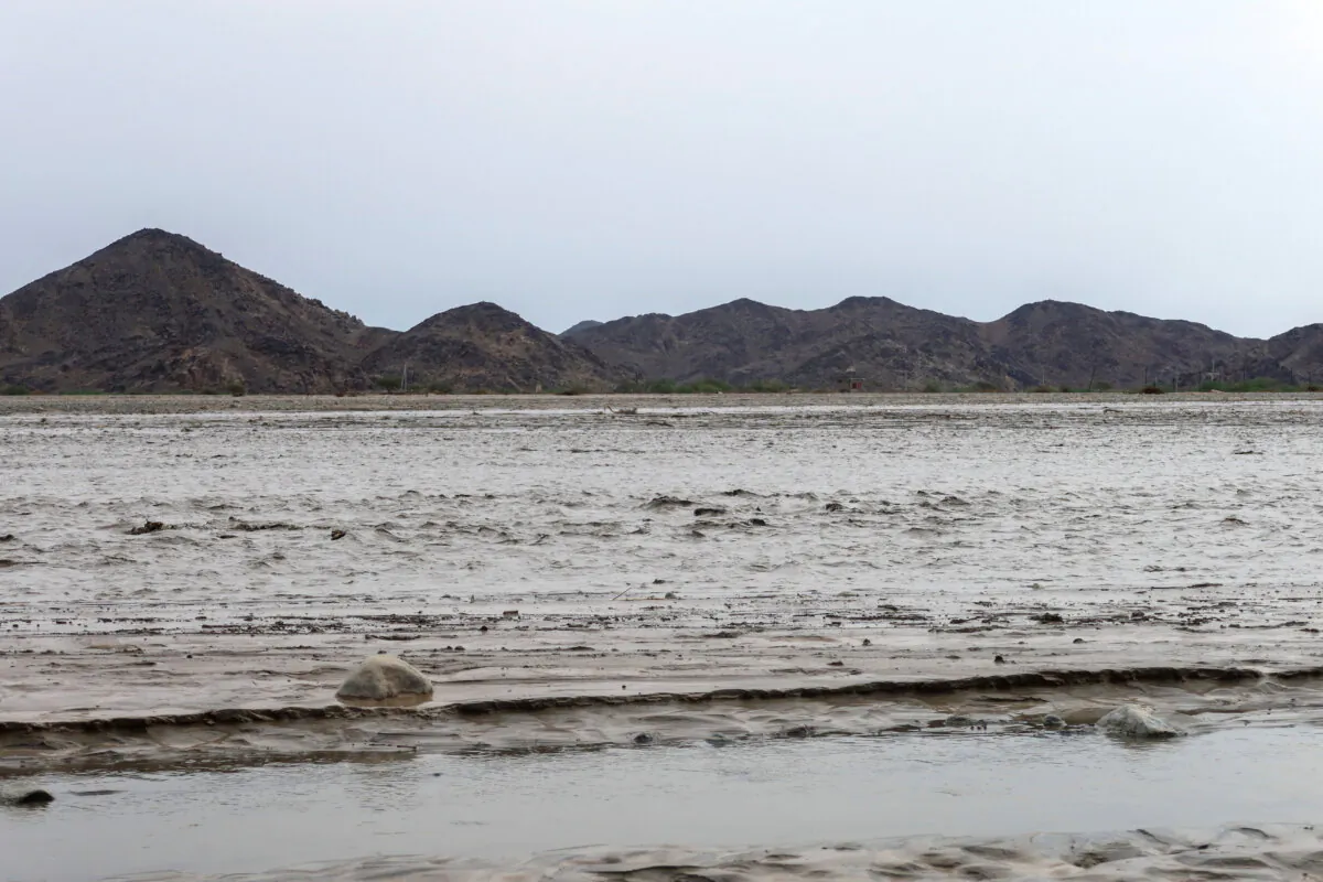 Flood water creates a channel, with the Red Sea mountains visible in the background, in Port Sudan, Sudan, on Aug. 26, 2024. (El Tayeb Siddig/Reuters)