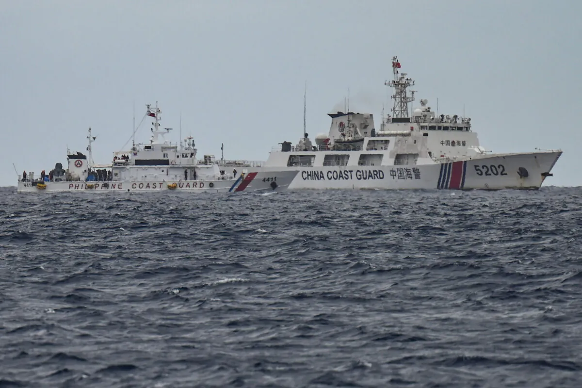 A China Coast Guard ship (R) is seen past the Philippine Coast Guard ship BRP Cape Engaño (L), as photographed from the BRP Cabra during a supply mission in disputed waters of the South China Sea on Aug. 26, 2024. (Jam Sta Rosa/AFP via Getty Images)