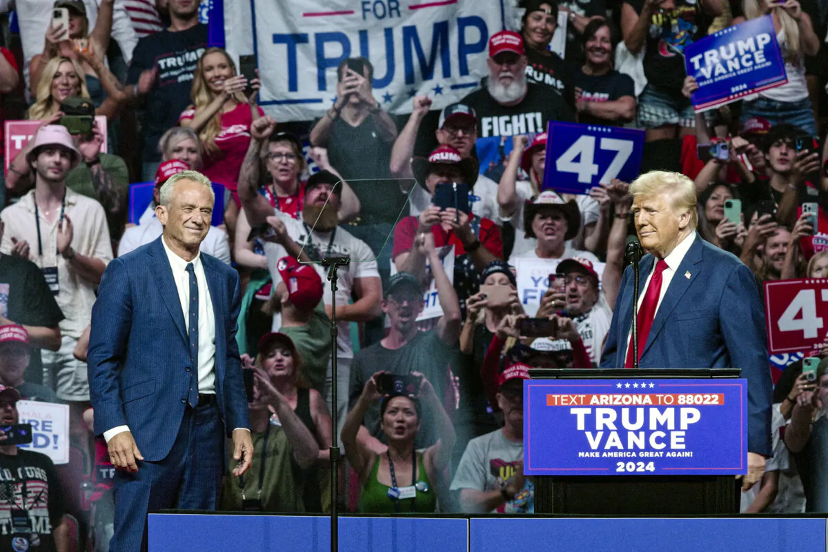 Former President and Republican presidential nominee Donald Trump (R) welcomes onstage Independent presidential candidate Robert F. Kennedy Jr. (L) during a campaign rally at the Desert Diamond Arena in Glendale, Ariz., on Aug. 23, 2024. (Olivier Touron/AFP via Getty Images)
