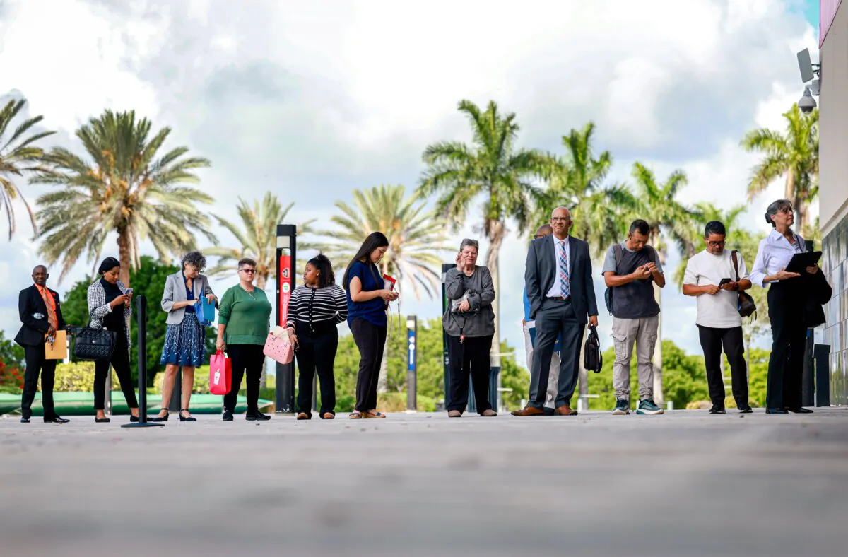 People wait in line for a job fair to open, in Sunrise, Fla., on June 26, 2024. (Joe Raedle/Getty Images)
