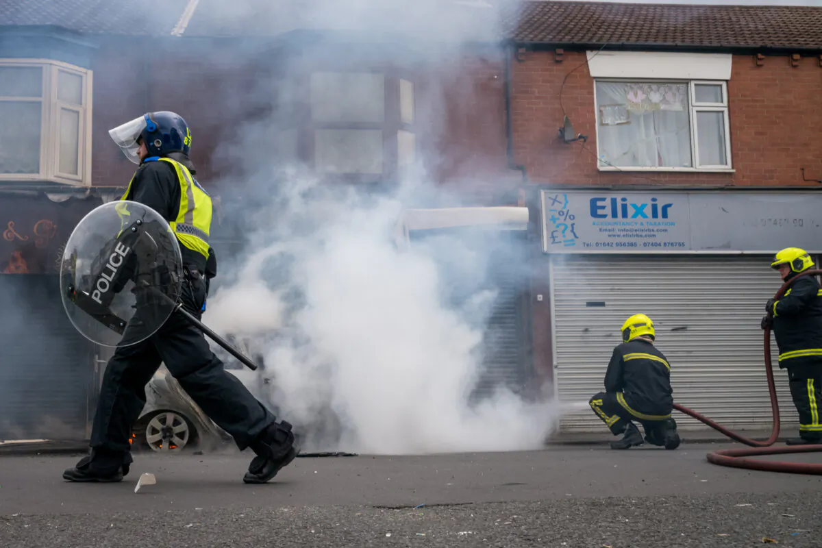 Firefighters extinguish a car fire after it was set alight by protesters in Middlesbrough, England, on Aug. 4, 2024. (Ian Forsyth/Getty Images)