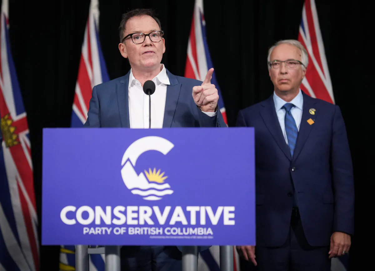 BC United Leader Kevin Falcon (L) speaks as BC Conservative Leader John Rustad listens during a news conference in Vancouver on Aug. 28, 2024. (The Canadian Press/Darryl Dyck)