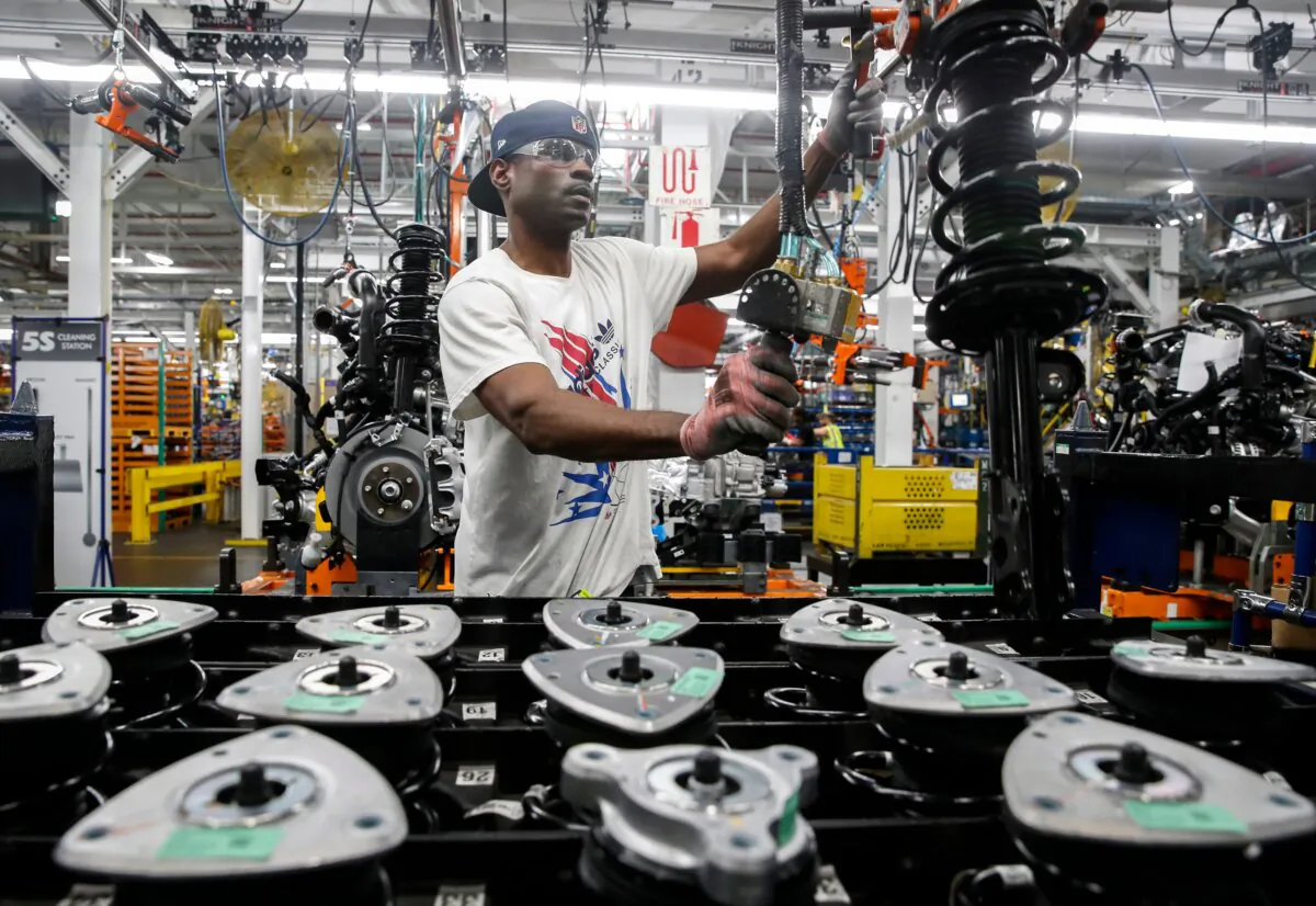 Workers assemble cars at the newly renovated Ford's Assembly Plant in Chicago on June 24, 2019. (Jim Young/AFP via Getty Images)
