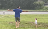 Dad and Toddler Dance Together in the Rain