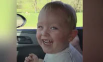Toddler Laughs at Ostrich Eating
