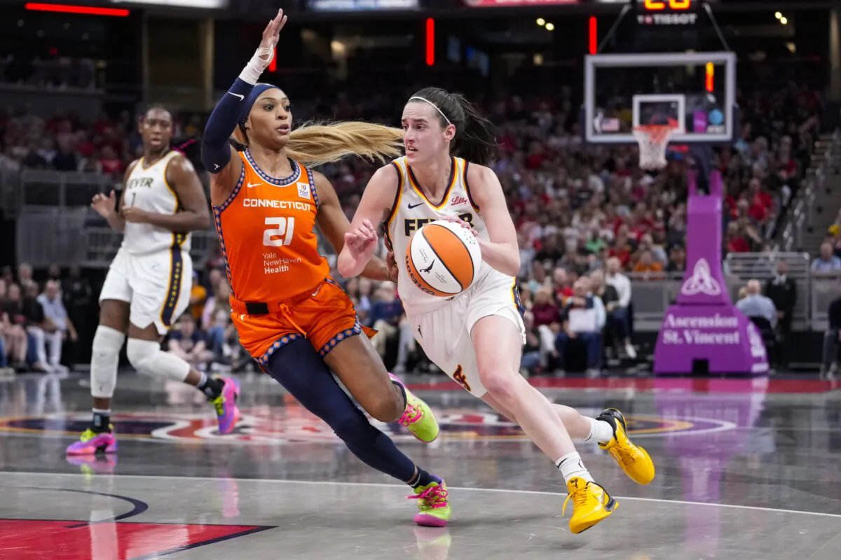 Indiana Fever guard Caitlin Clark (22) drives on Connecticut Sun guard DiJonai Carrington (21) in the second half of a WNBA basketball game in Indianapolis on Aug. 28, 2024. (Michael Conroy/AP Photo)