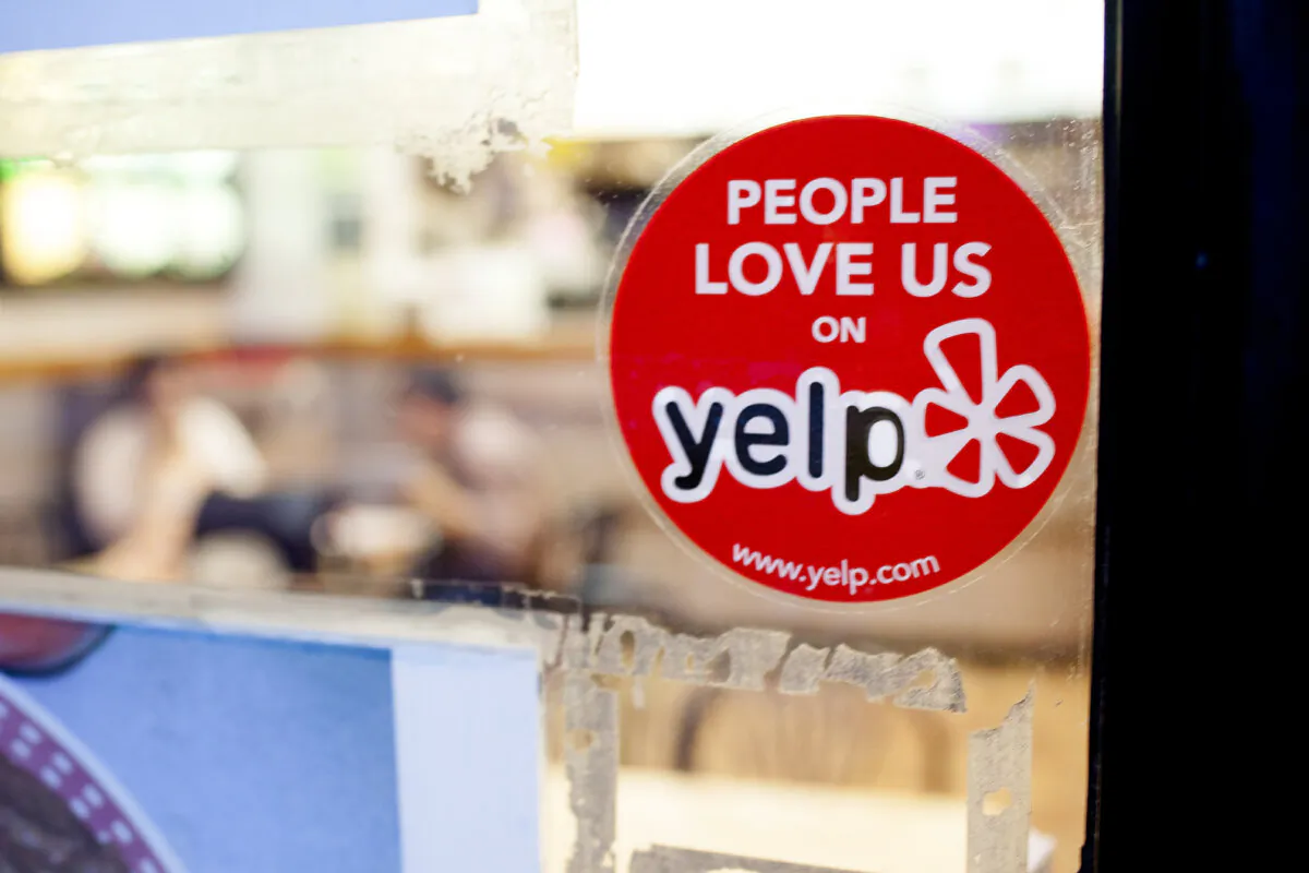 A Yelp sticker on a restaurant in the Chelsea neighborhood of Manhattan in this file photo. (Petr Svab/Epoch Times)