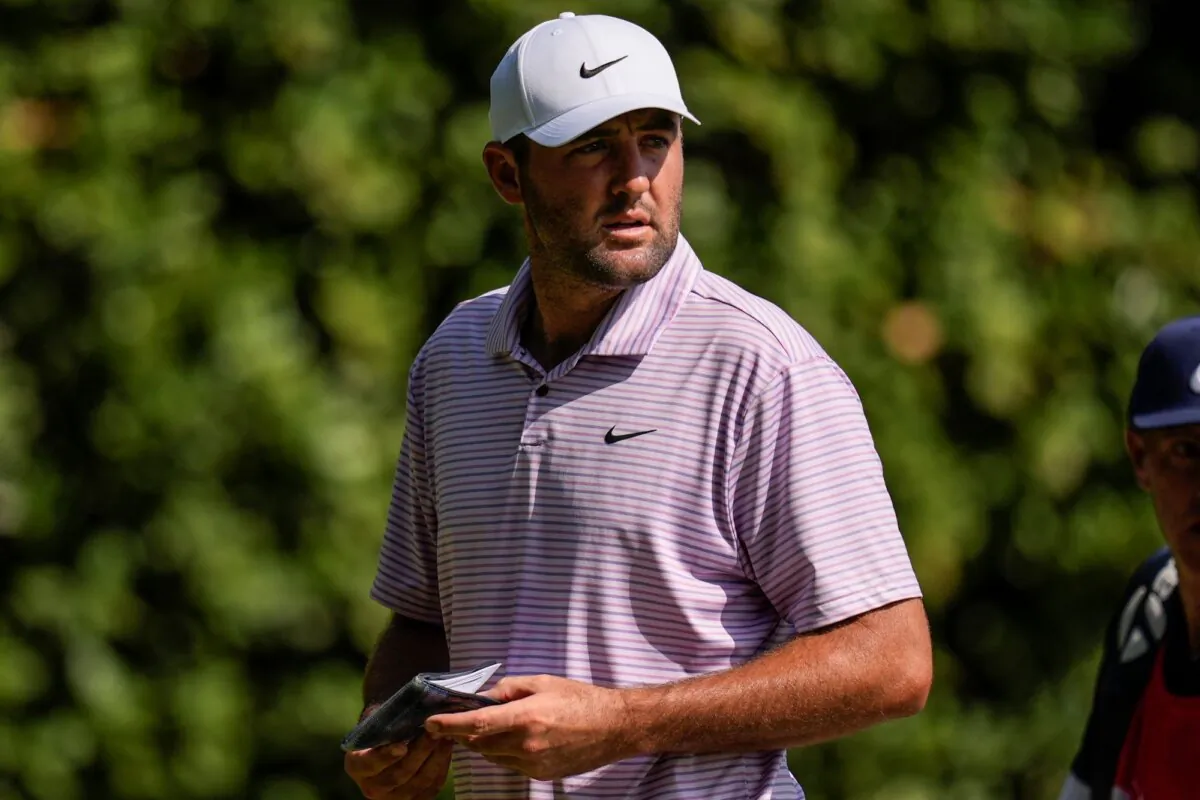 Scottie Scheffler walks off the 11th green during the first round of the Tour Championship in Atlanta on Aug. 29, 2024. (Mike Stewart/AP Photo)