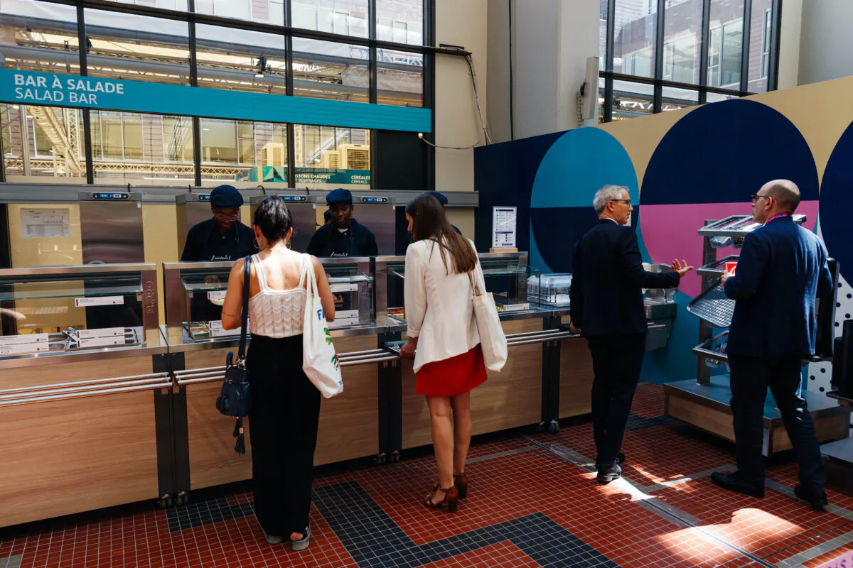 Visitors choose their meal during a test event of the Paris 2024 Olympic and Paralympic Village restaurant at the Cité du Cinéma in the Olympic Village in Saint-Denis, France, on June 25, 2024. (Dimitar Dilkoff/AFP/Getty Images)