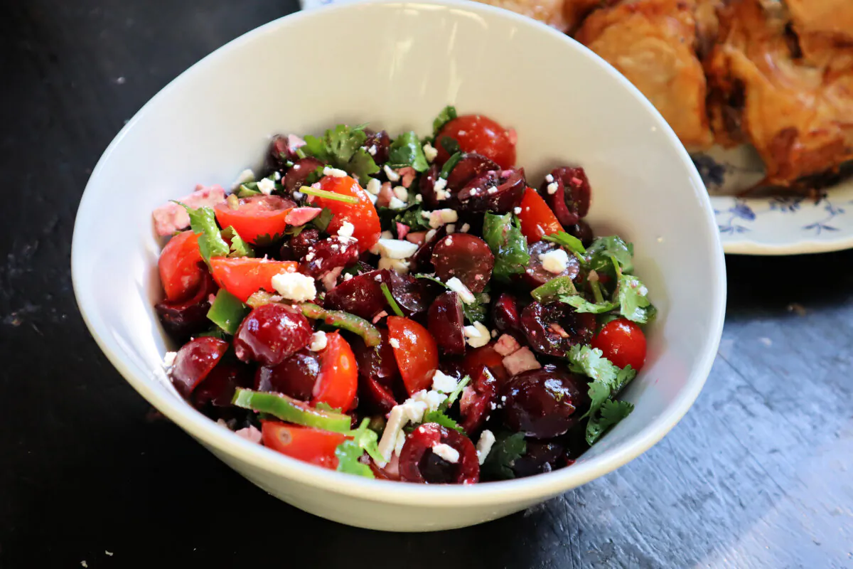 A salad of sweet cherries paired with grapes, cherry tomatoes and jalapeno adds a seasonal zing to a platter of roast chicken. (Gretchen McKay/Pittsburgh Post-Gazette/TNS)