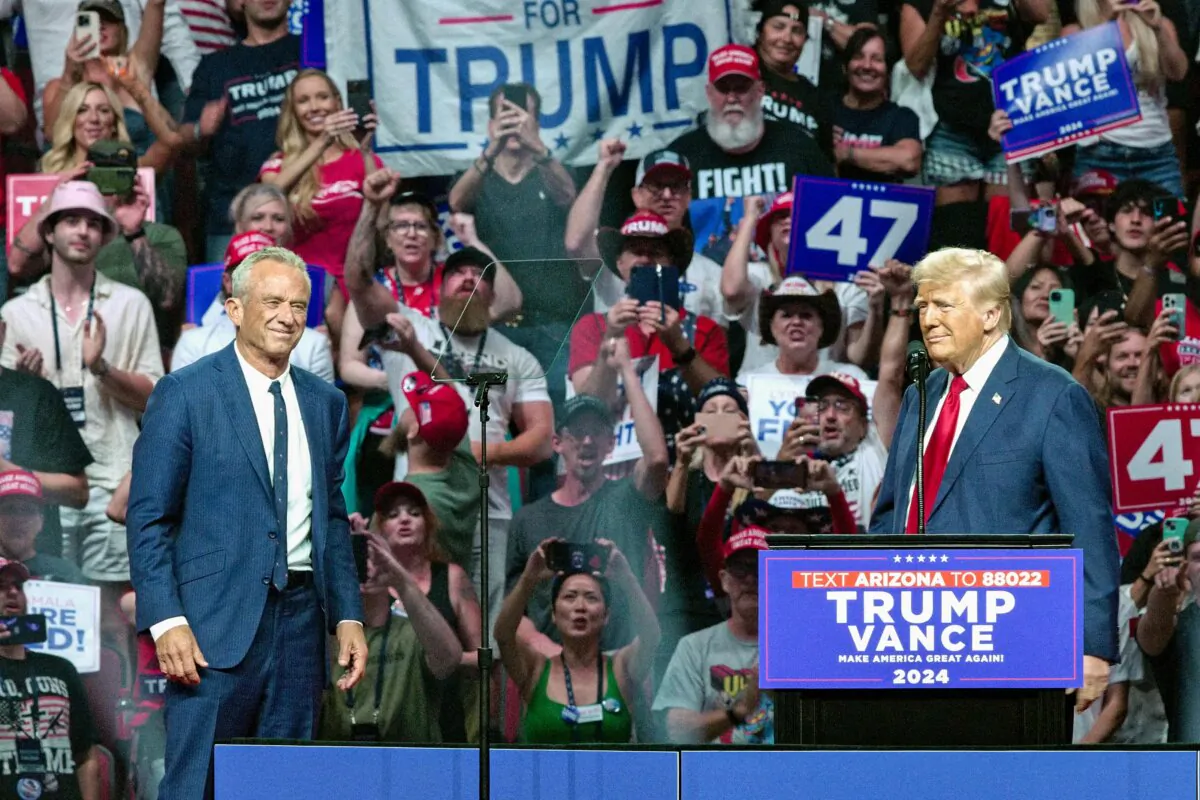 Former President and Republican presidential nominee Donald Trump (R) welcomes onstage Independent presidential candidate Robert F. Kennedy Jr. (L) during a campaign rally at the Desert Diamond Arena in Glendale, Ariz., on Aug. 23, 2024. (Olivier Touron/AFP via Getty Images)
