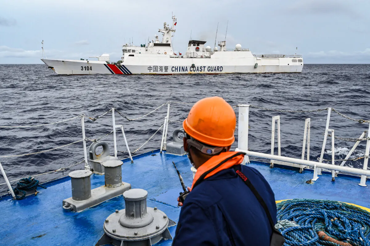 A Chinese coast guard ship glides past the Philippine Coast Guard vessel BRP Cabra during a supply mission to Sabina Shoal in the South China Sea on Aug. 26, 2024. (Jam Sta Rosa/AFP via Getty Images)