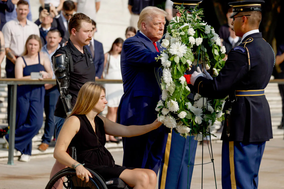 Republican presidential nominee and former President Donald Trump lays a wreath alongside Marine Cpl. Kelsee Lainhart (Ret.) and U.S. Marine Corps. Sgt. Tyler Vargas-Andrews (Ret.), who were injured at the Abbey Gate Bombing, during a wreath-laying ceremony at the Tomb of the Unknown Soldier in Arlington, Va., on Aug. 26, 2024. (Anna Moneymaker/Getty Images)